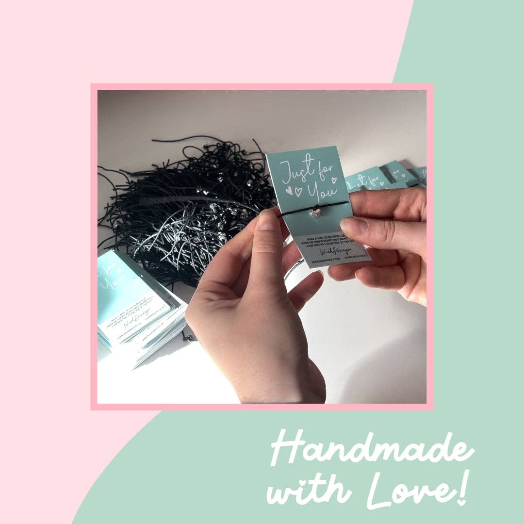 Hand holding a small card with 'Just for You' text, surrounded by decorative elements on a pink and green background.