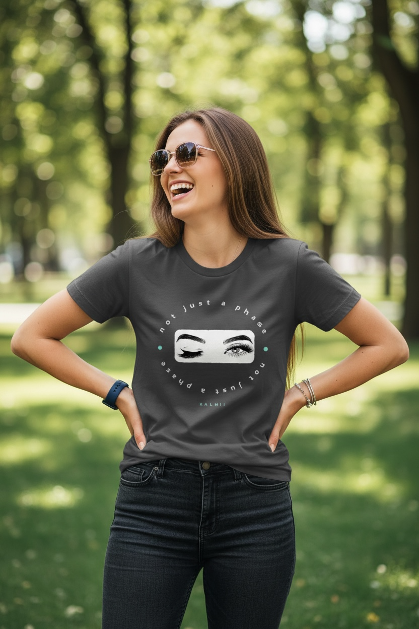 Woman wearing a dark gray t-shirt with a graphic design in a park
