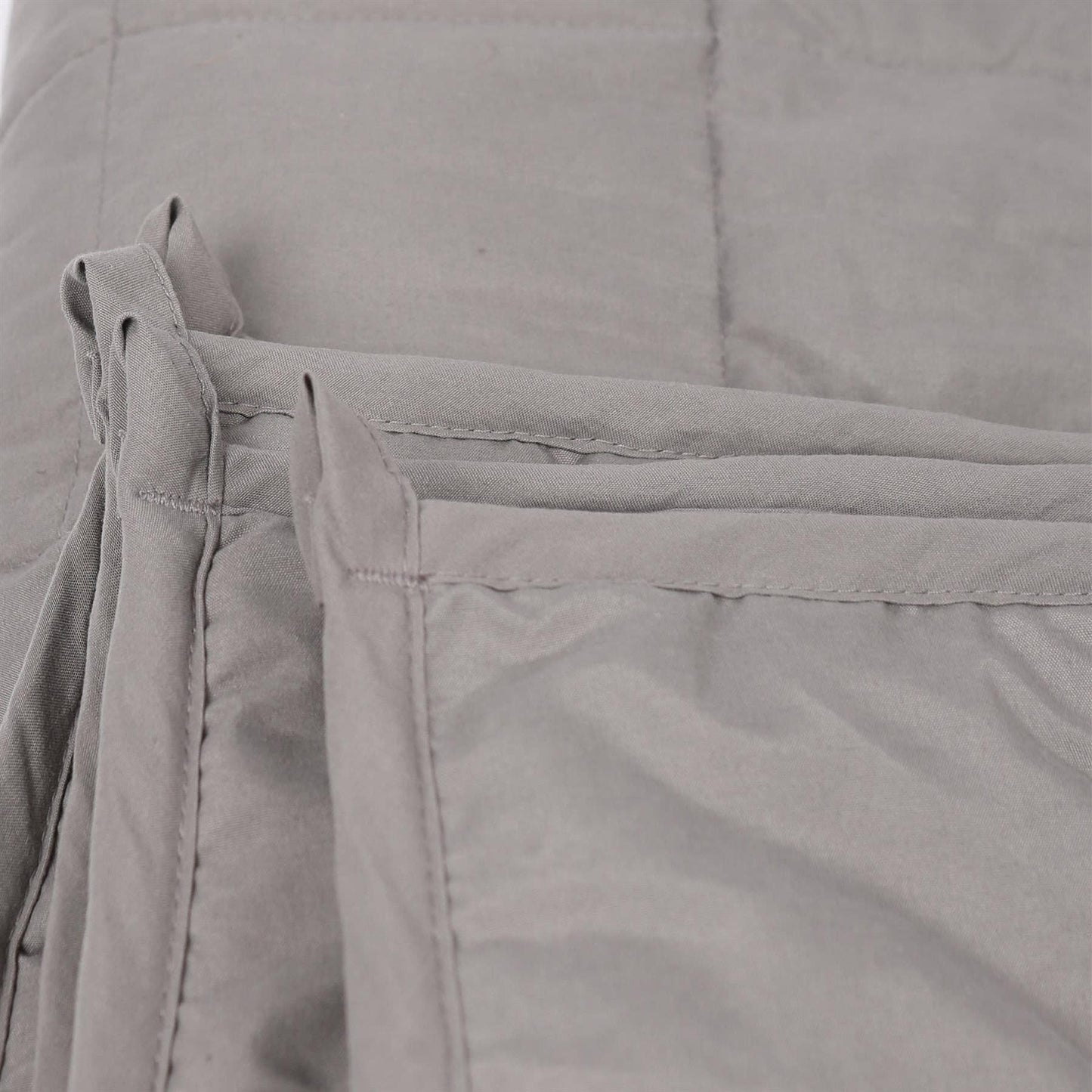 Close-up of gray weighted blanket with a focus on the fabric texture.