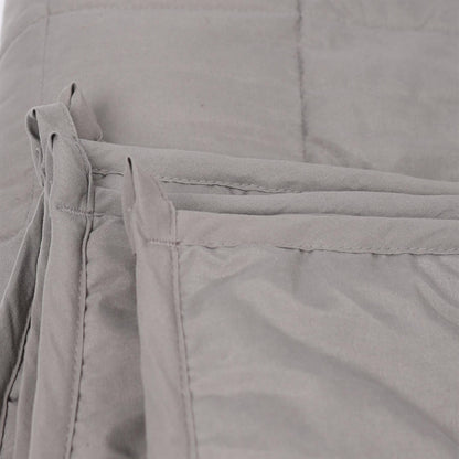 Close-up of gray weighted blanket with a focus on the fabric texture.