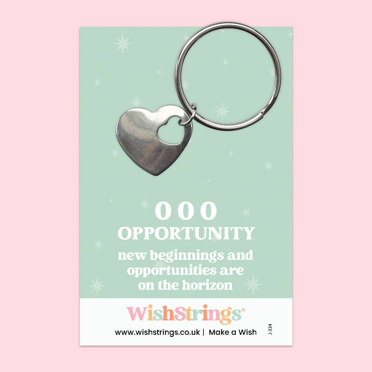 Heart-shaped keychain on a WishStrings branded card with motivational text on a pink background
