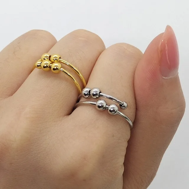 Gold and silver ring set on a hand against a white background
