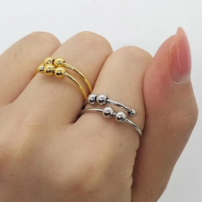 Gold and silver ring set on a hand against a white background