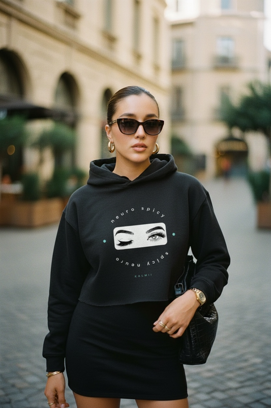 Woman wearing a black hoodie with a graphic design on a city street