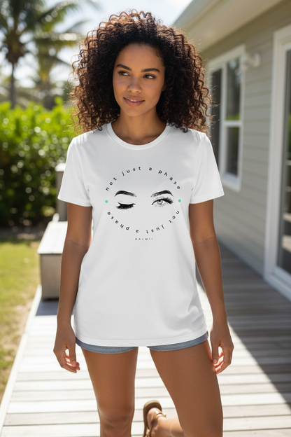 Woman wearing a white t-shirt with a graphic design outdoors.