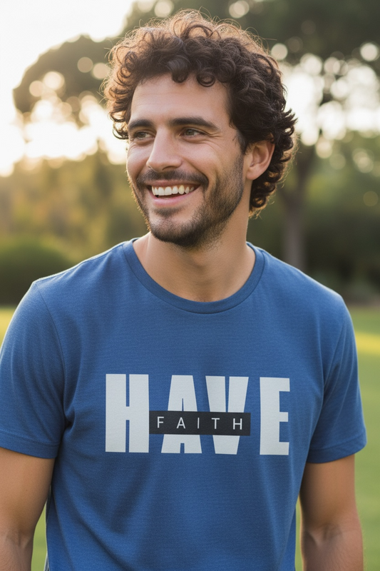 Man wearing a blue t-shirt with 'HAVE FAITH' text outdoors