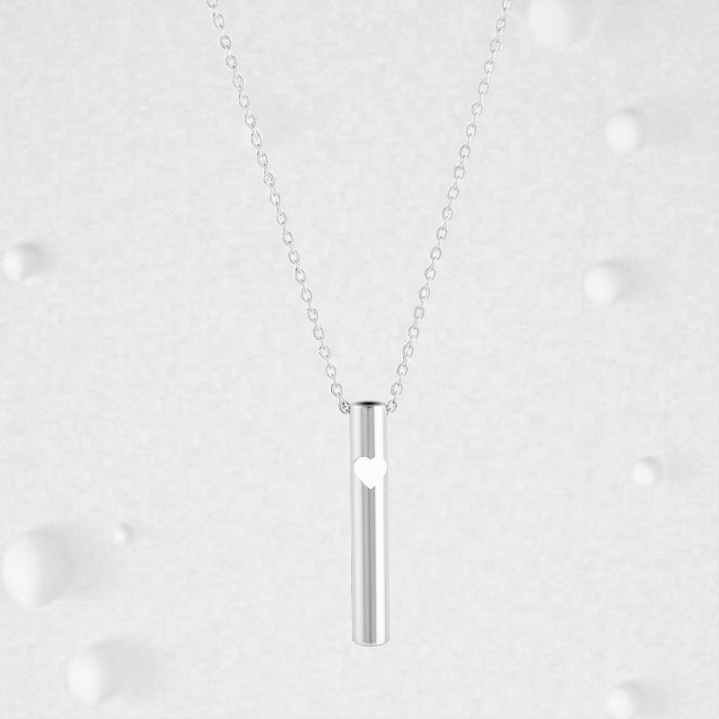 KALMii Anxiety Necklace set against a pale background. Silver pendant with white heart 