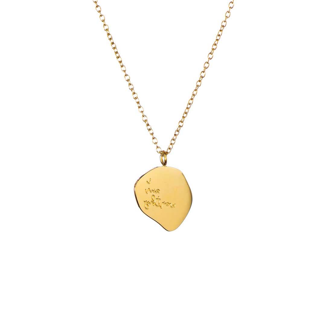 Gold necklace with a leaf-shaped pendant on a white background