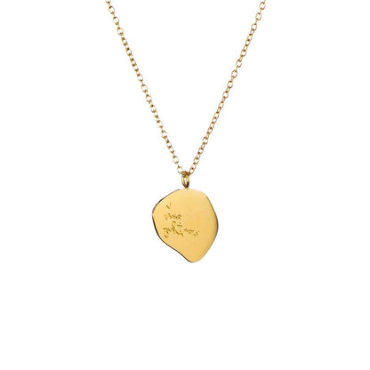 Gold necklace with a leaf-shaped pendant on a white background