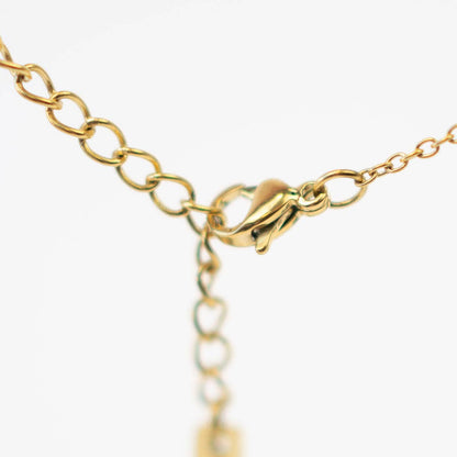 Gold bracelet with clasp on a white background