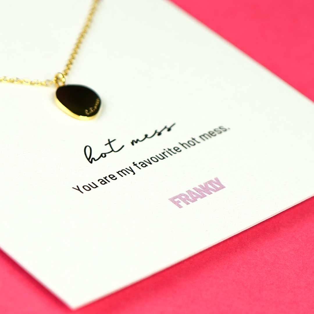 Necklace with a card that reads 'hot mess, you are my favourite hot mess, FRANKLY' on a pink background