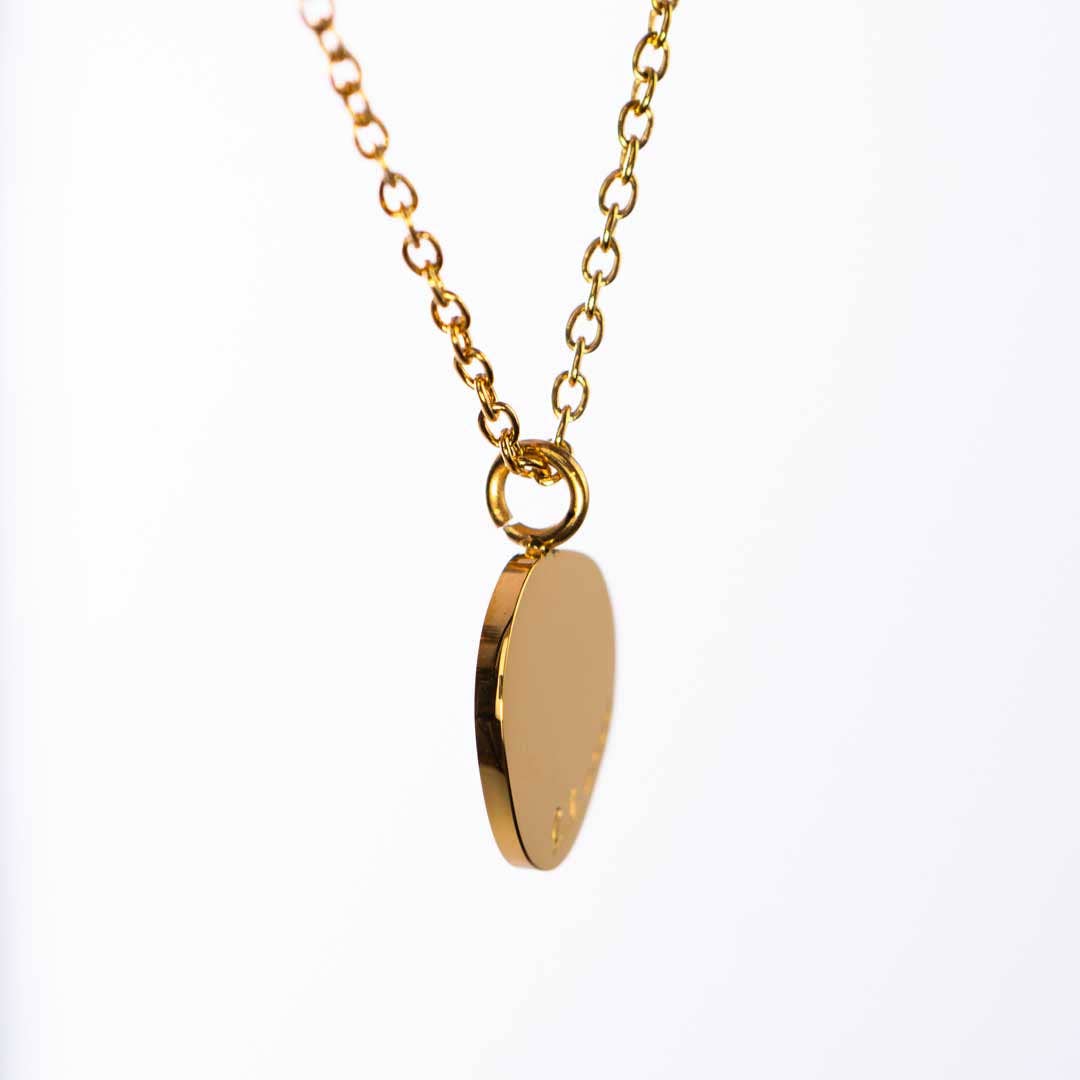 Gold necklace with a teardrop-shaped pendant on a white background