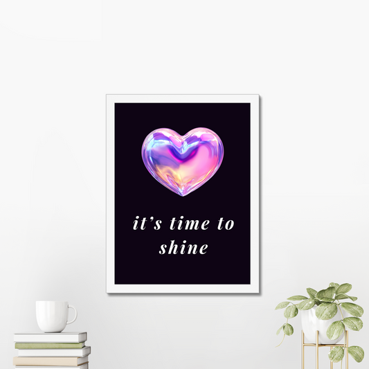 Framed artwork with a heart-shaped object and 'it's time to shine' text on a white wall by KALMii